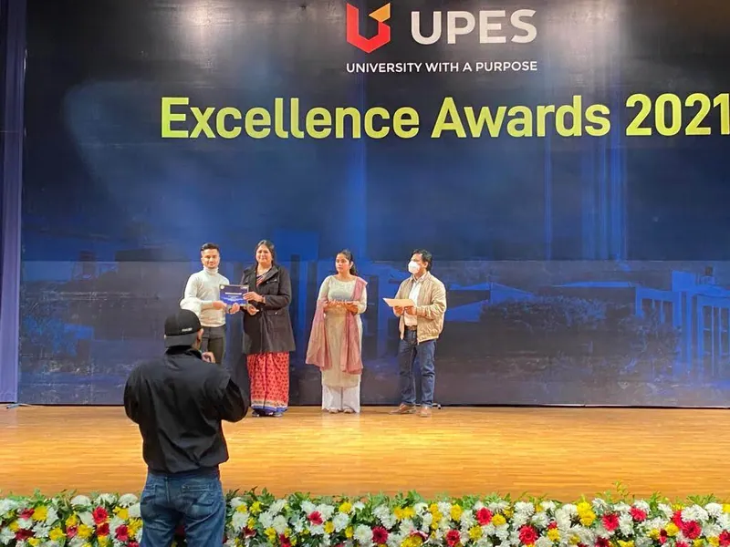Kousik receiving an award onstage at the UPES Excellence Awards 2021